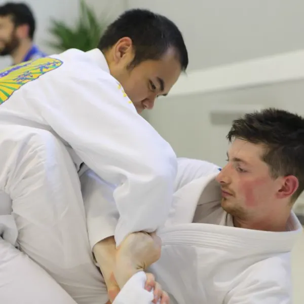 Two students sparring on the mats at Brazier Jiu Jitsu